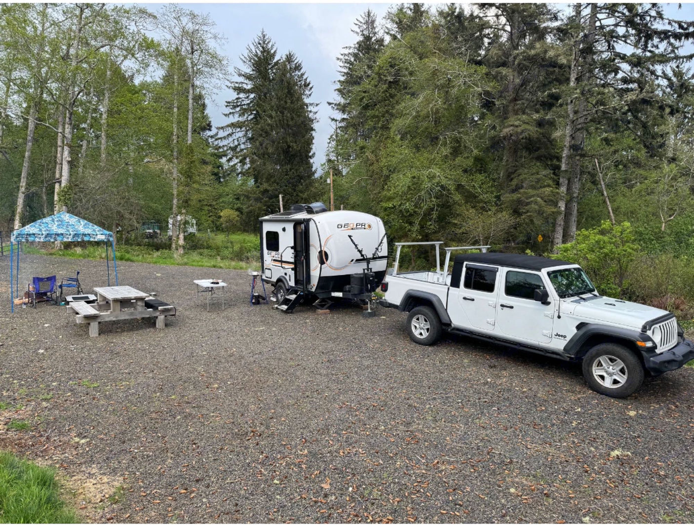 dry grassy field under clear skies.|Cozy RV rental camping setup with a dog