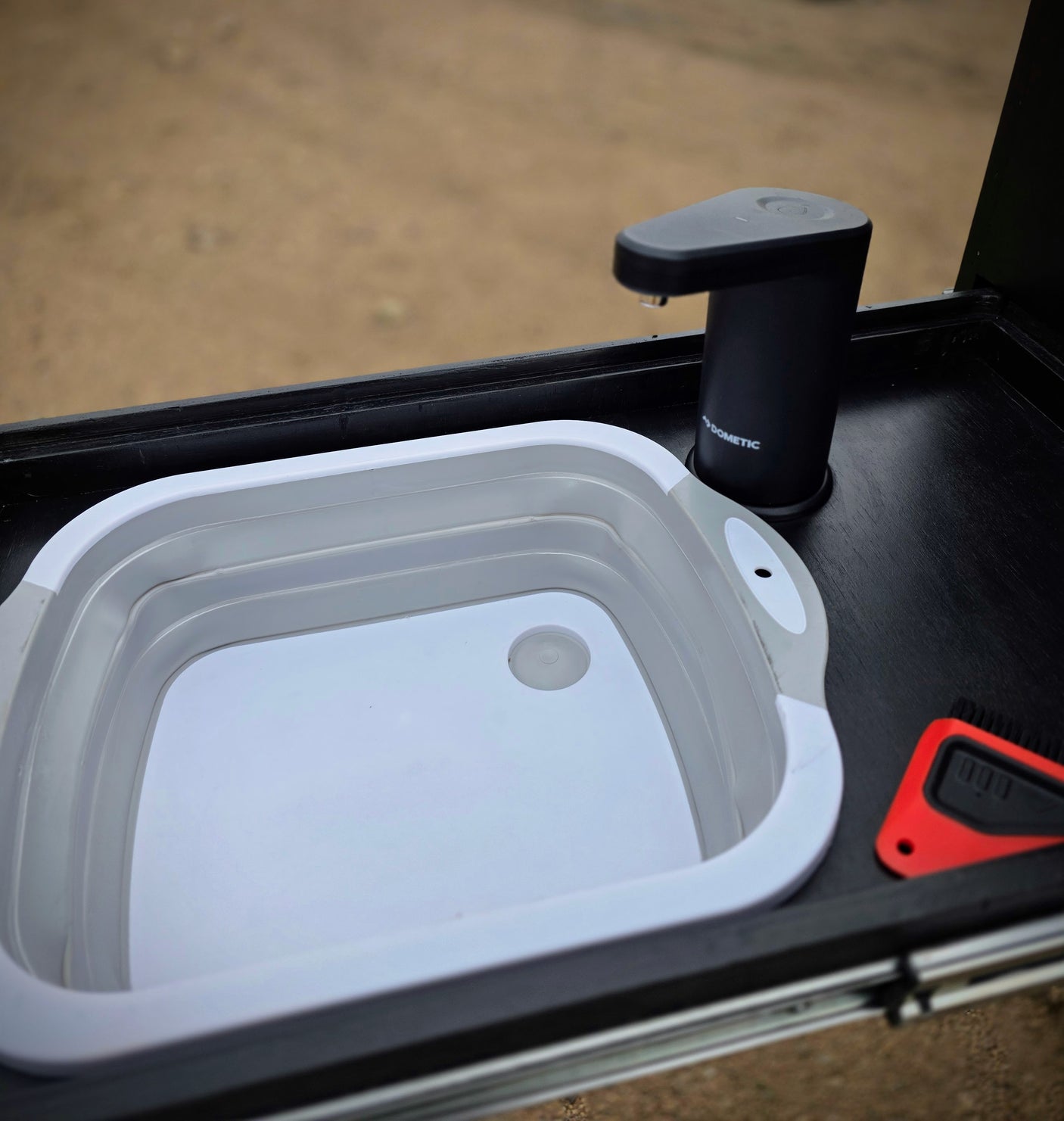RV rental ready: Dometic portable faucet & collapsible sink for convenient outdoor dishwashing, perfect for camping hygiene.