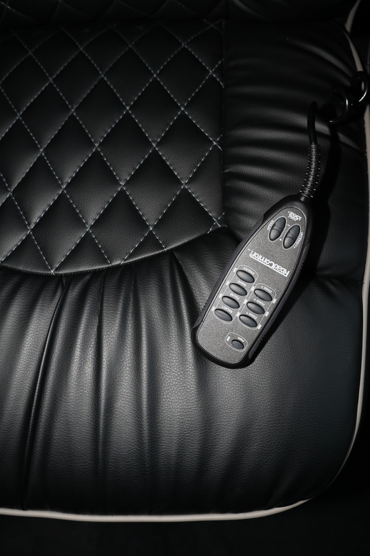 Luxury massage seat with "RoadComfort" remote control in an RV rental, providing enhanced travel comfort.