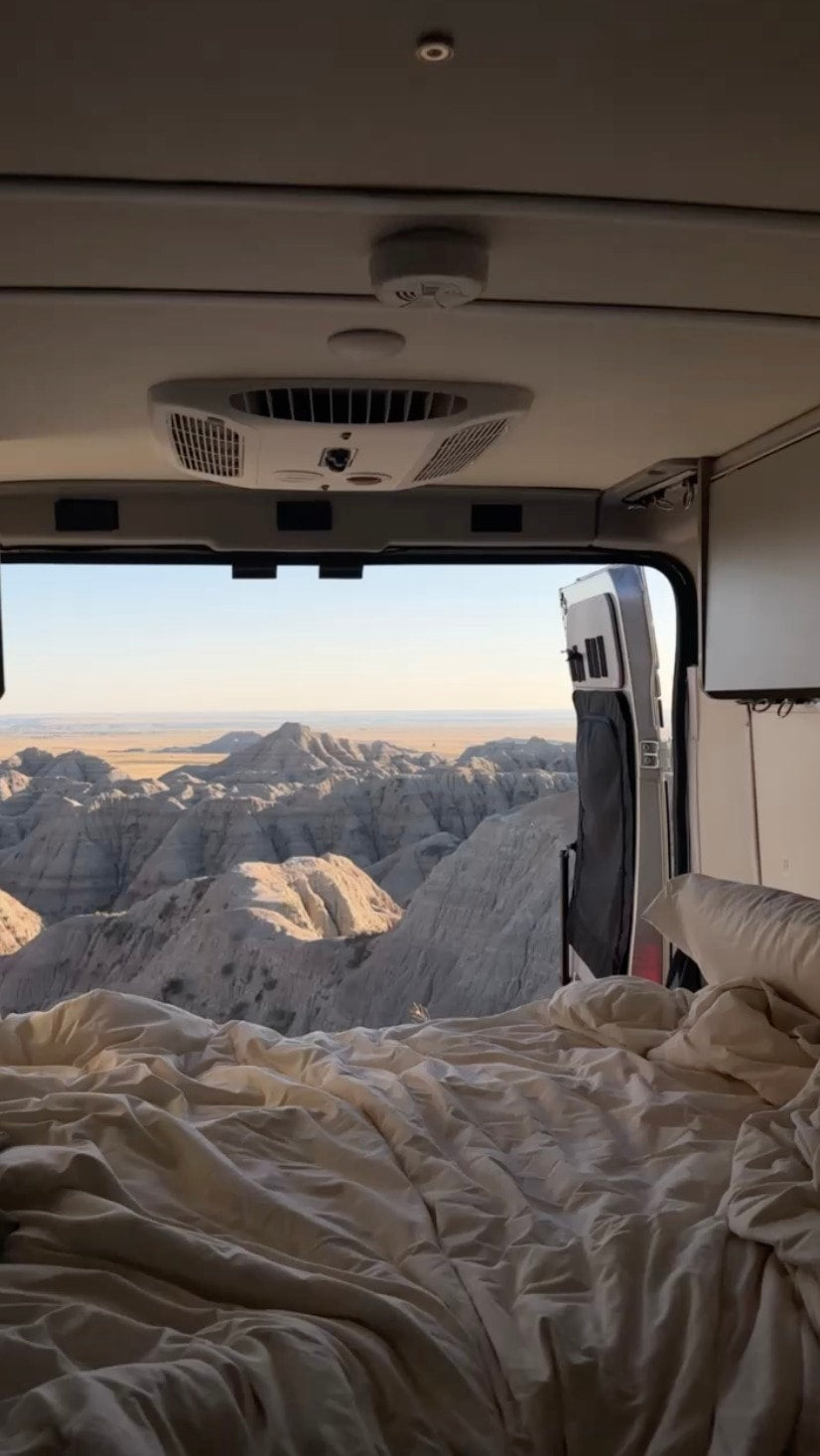 smoke detector. Perfect for scenic travel!|Interior of an RV rental camper van with open side door