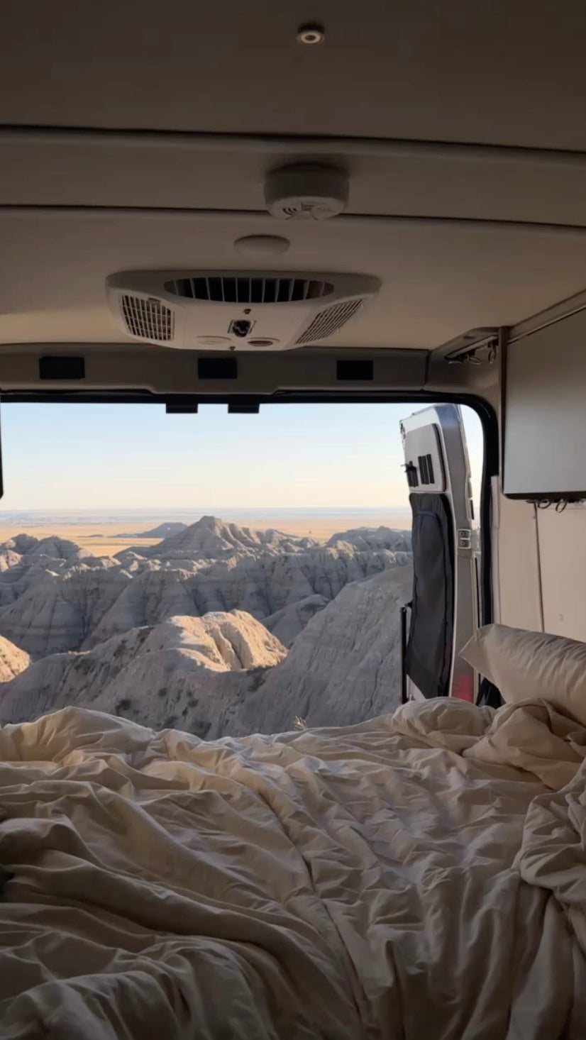 smoke detector. Perfect for scenic travel!|Interior of an RV rental camper van with open side door