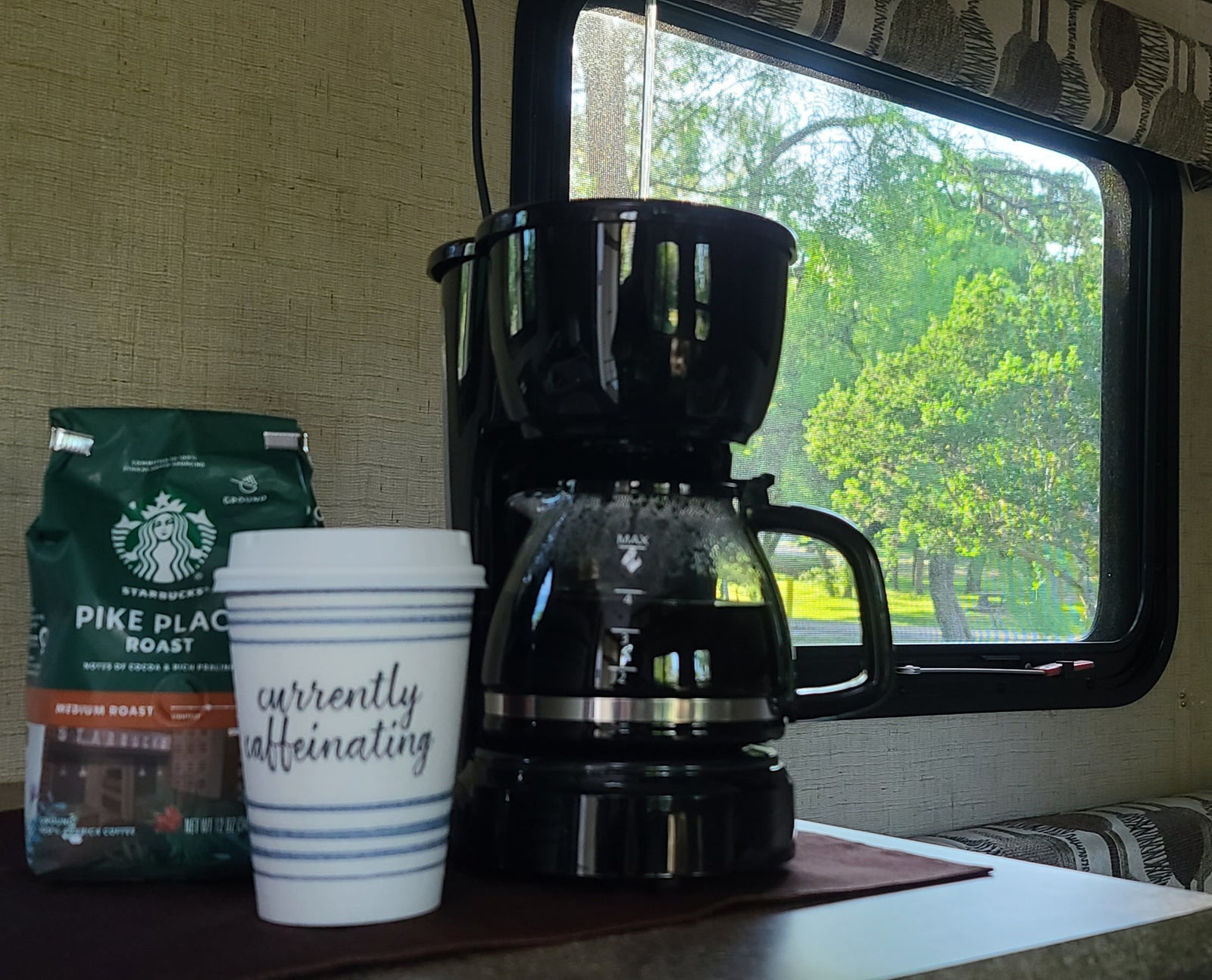 and windows showing outdoor scenery.|RV rental bathroom showing toilet