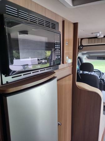 and rear bed setup.|Detailed view of an RV rental's spacious cabin