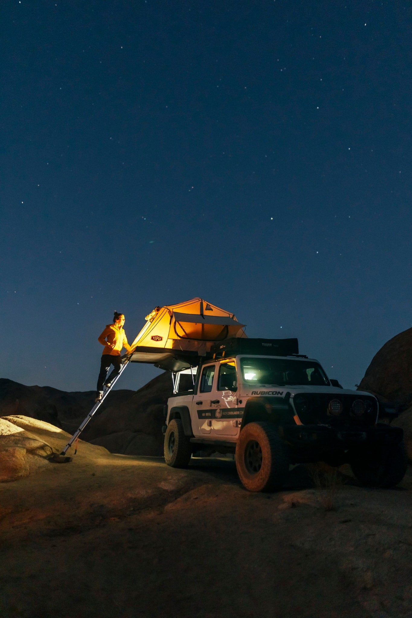 perfect for your next **rv rental** escape.|A woman enjoys a campfire with her RV rental setup
