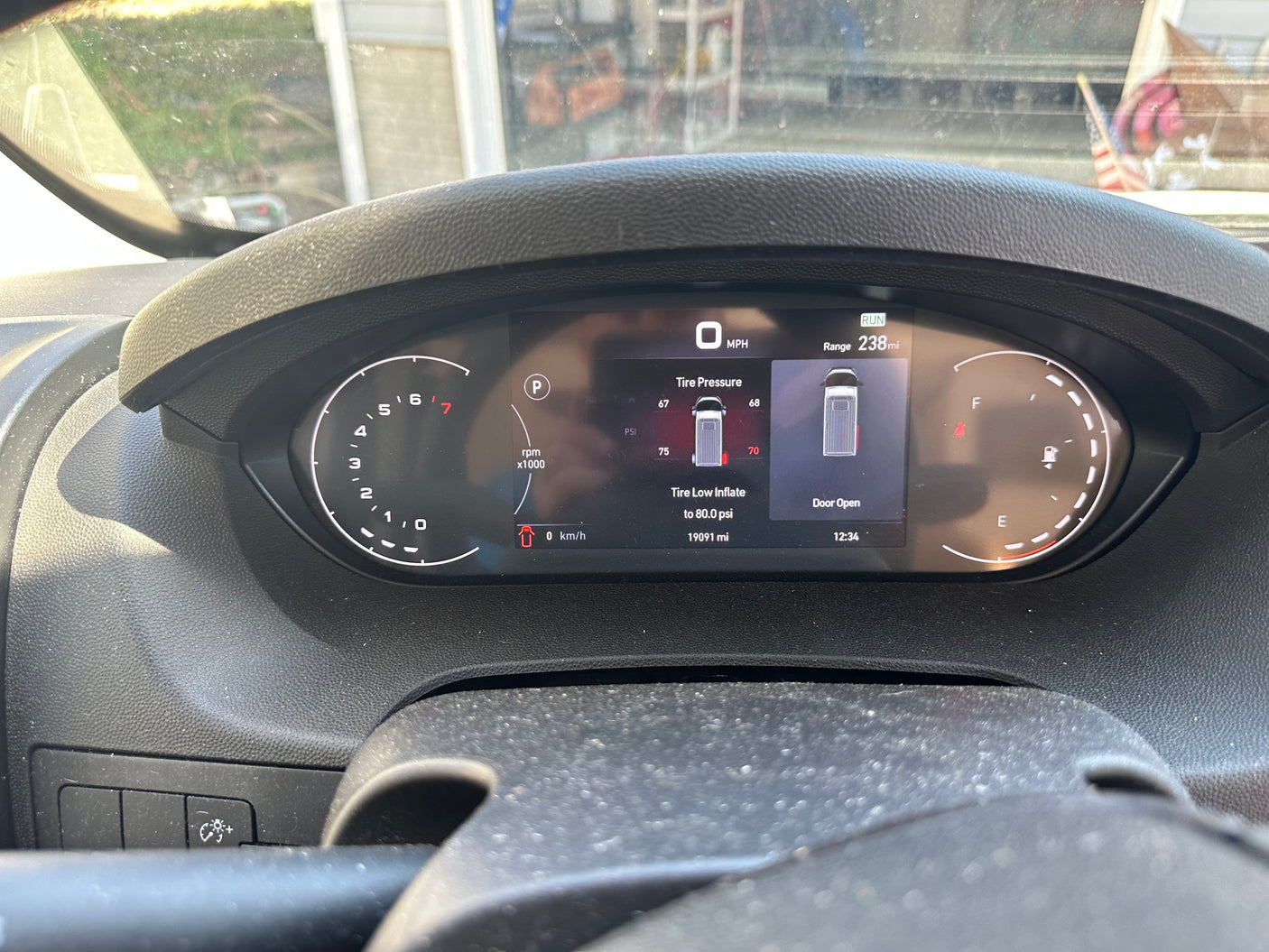 Digital dashboard of an **rv rental** showing a low **tire pressure** warning (70 PSI), an open door, 0 MPH, and 19091 miles.