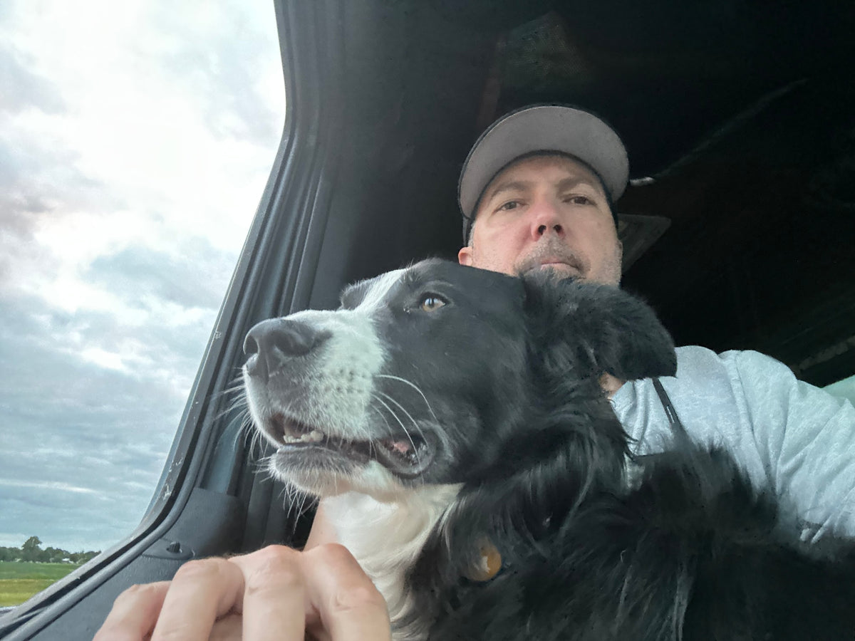 Travel buddy! Man and black & white dog enjoying the view from their RV rental window on a cloudy day. Adventure awaits. — photo 19