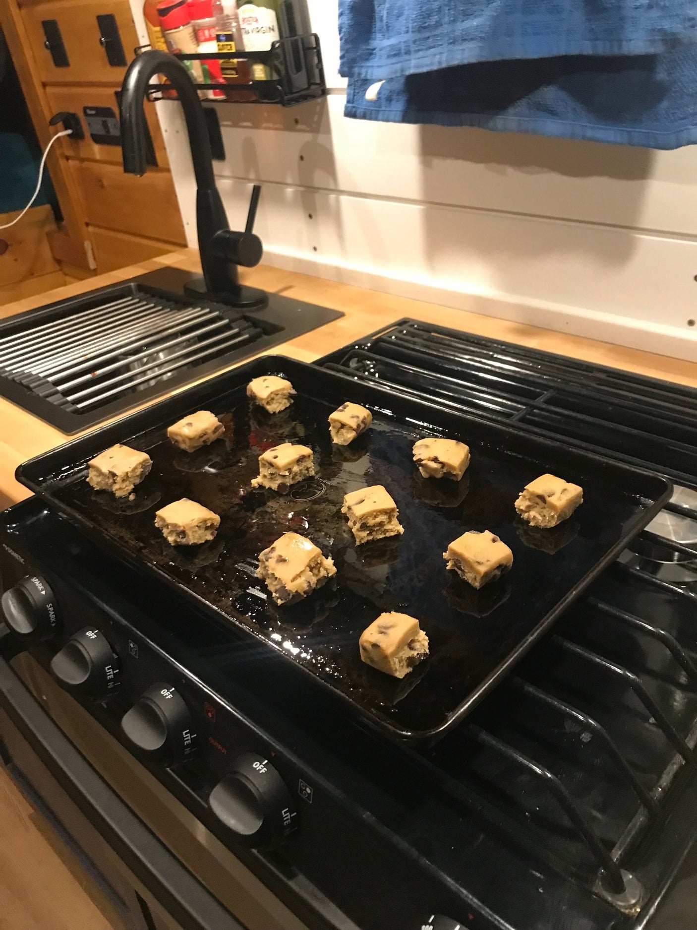 RV rental kitchen: Cookie dough squares on the stove, prepped for delicious baking.