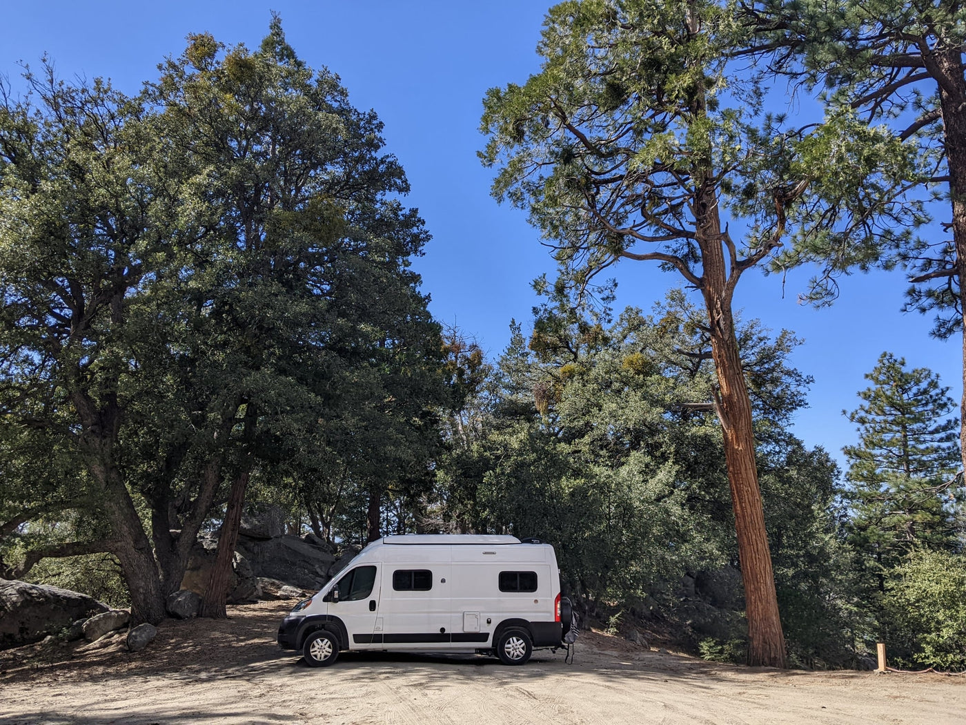 parked on a residential street.|White RV rental parked on a dirt road — photo 3