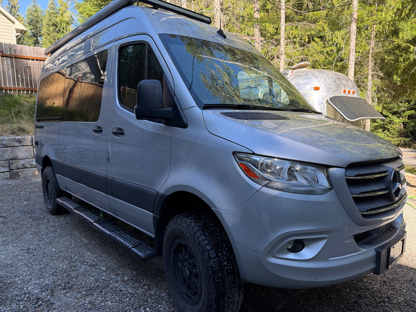 A silver Mercedes-Benz Sprinter camper van