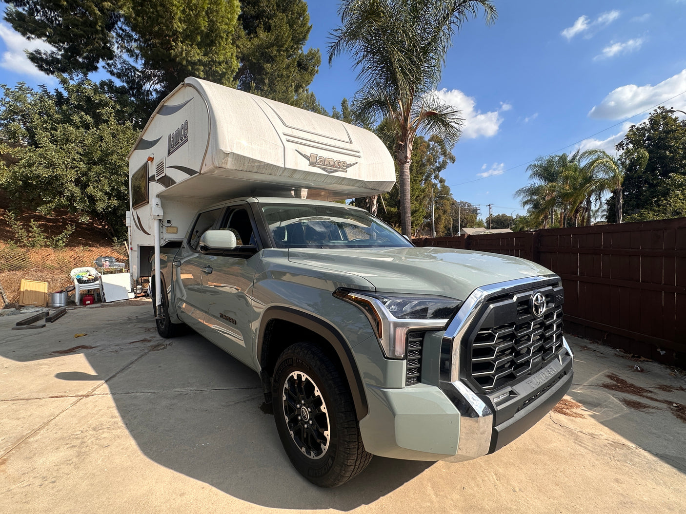 Light green Toyota Tundra with a Lance truck camper, perfect for an RV rental adventure!