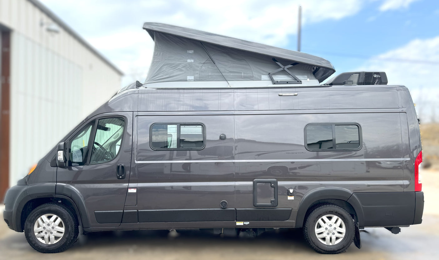 This gray pop-top camper van is ready for your next RV rental adventure, offering a compact and versatile travel experience.