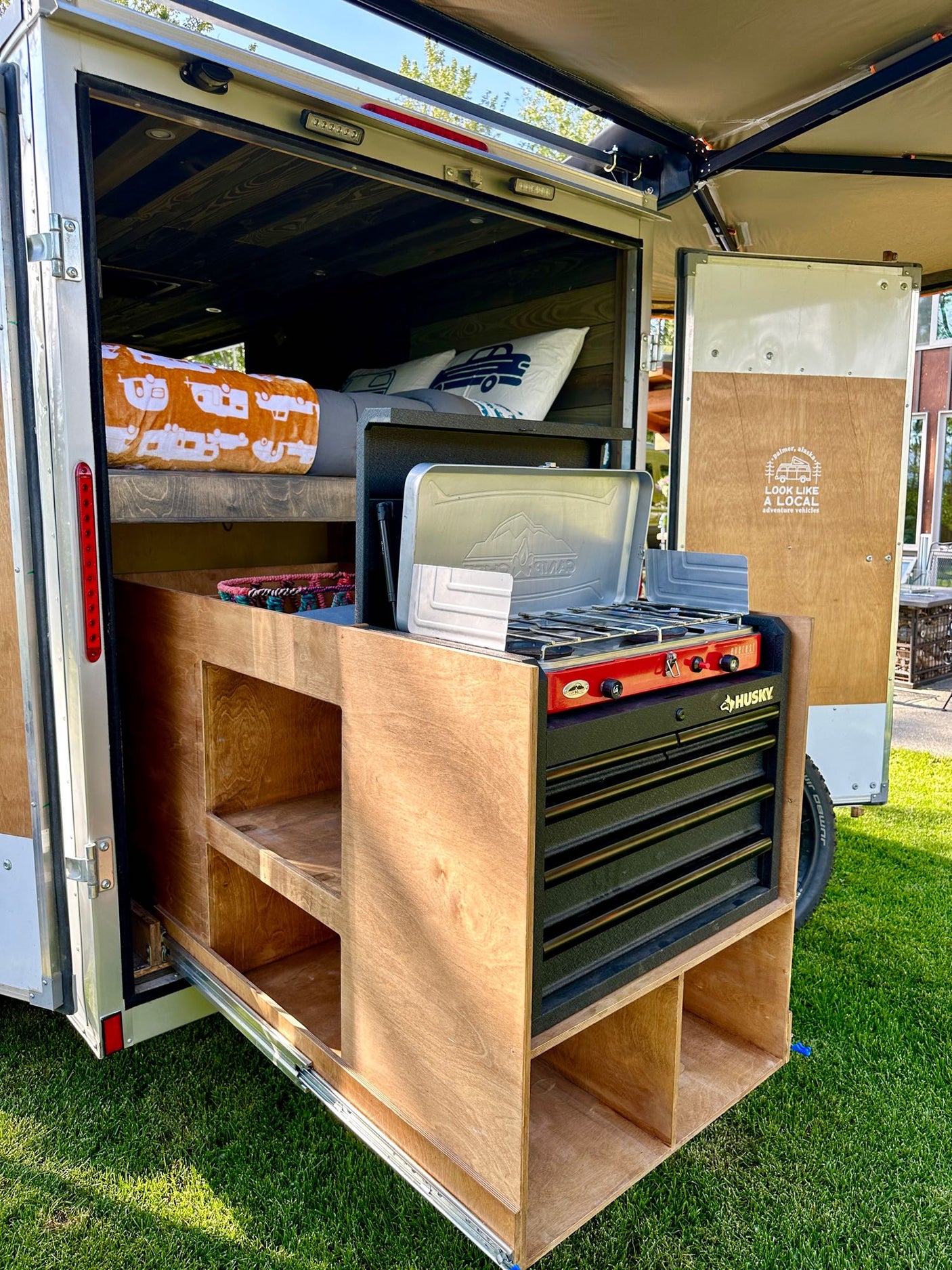 and drain setup for compact living.|Compact RV rental kitchen area featuring a dark countertop