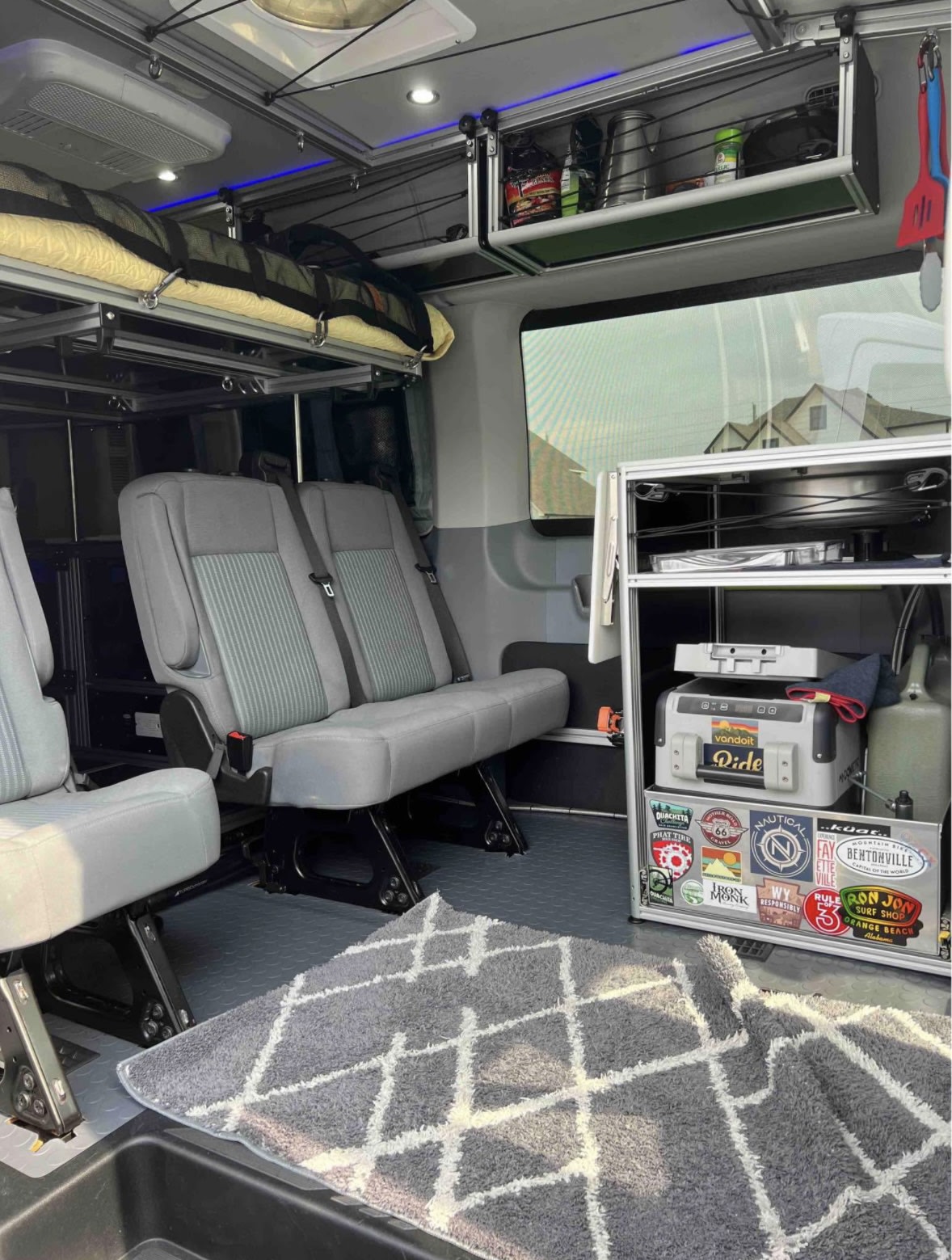 and colorful retro stripes.|RV rental: well-equipped van interior with seating