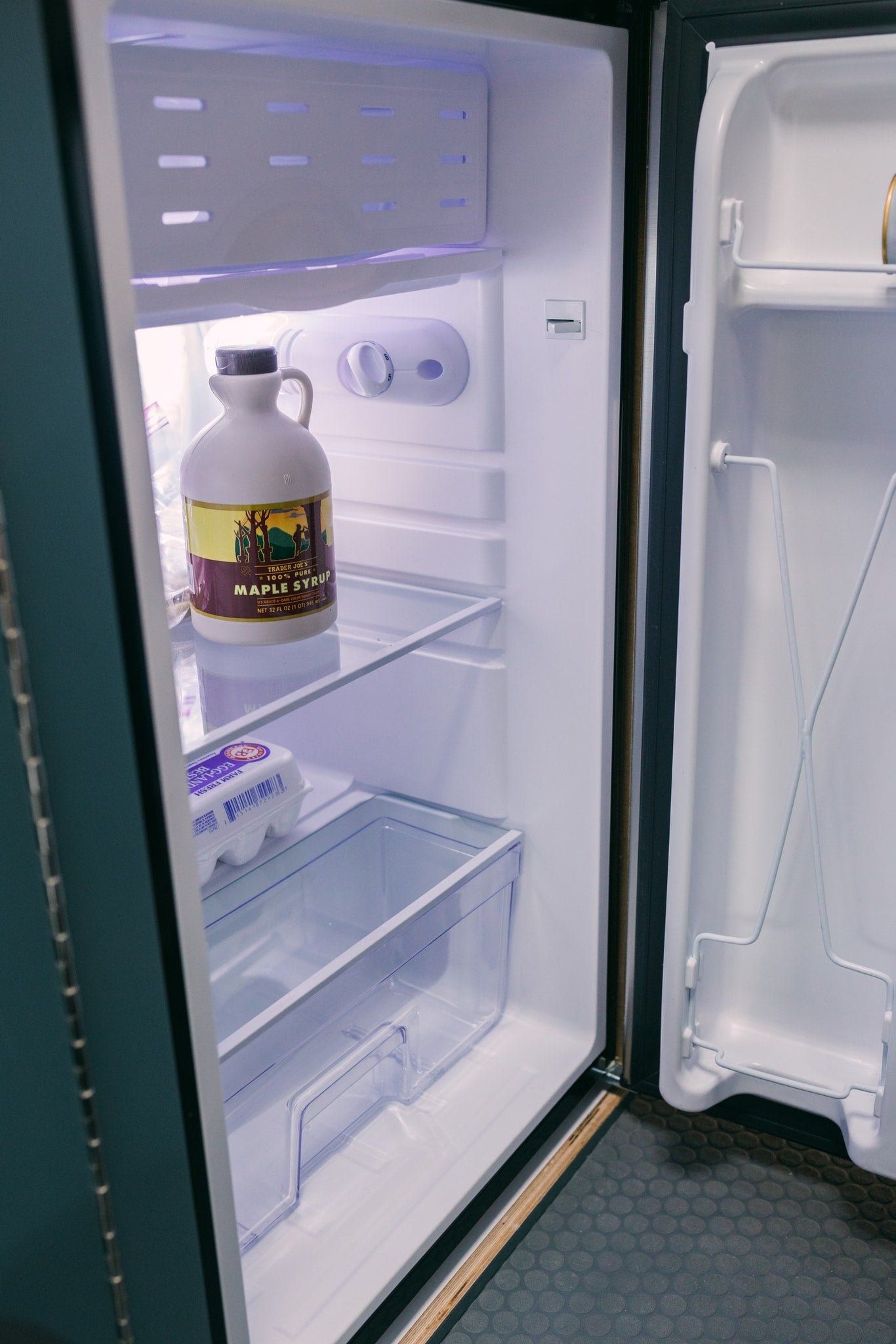 A clean RV rental fridge holds Trader Joe's maple syrup & Egg-Land's Best eggs, perfect for your next camping adventure. — photo 11
