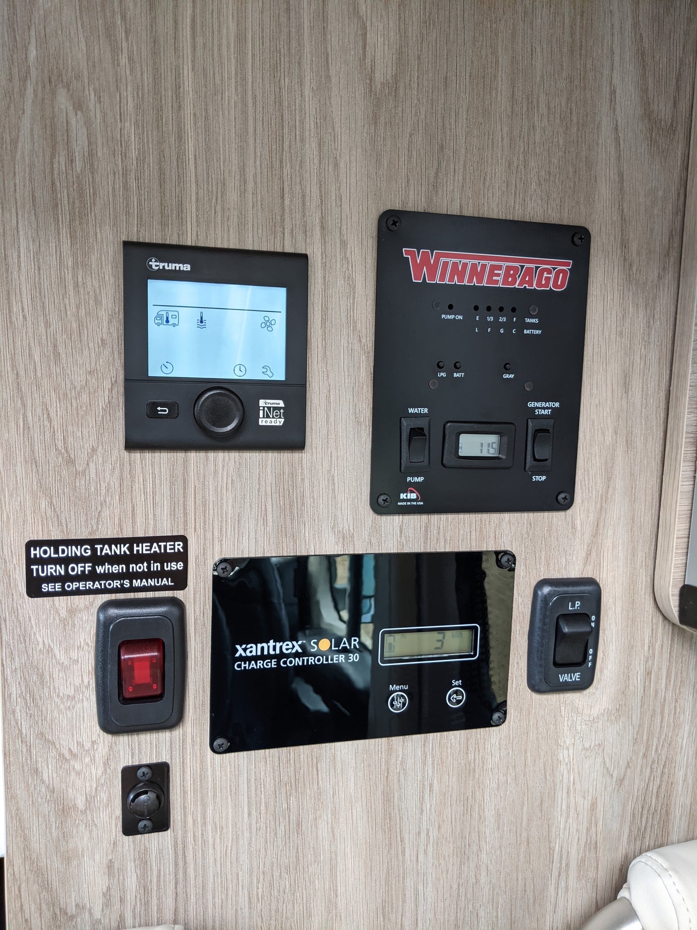 RV rental control panel for essential systems: tank levels, heating, solar charging, generator, and LP gas valve.
