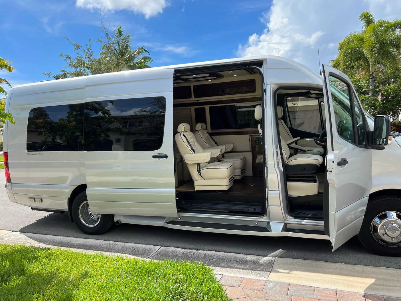 perfect for an RV rental adventure.|Luxury silver Mercedes Sprinter RV rental van. Open side door reveals a spacious
