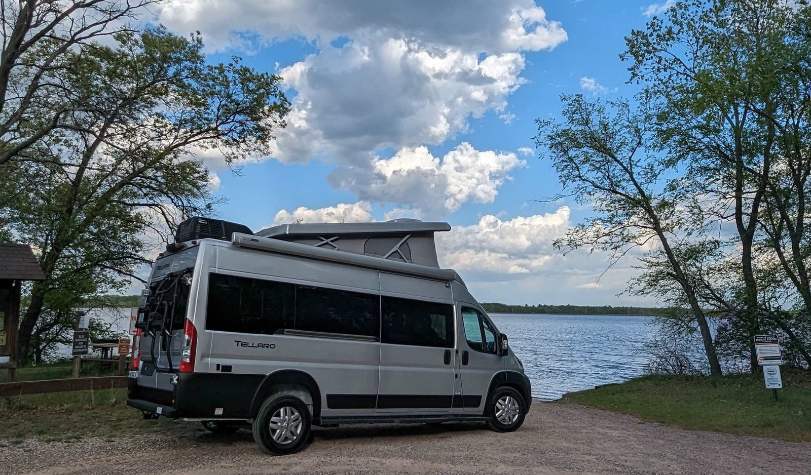 ready to launch into the scenic lake with boat docks.|A gray camper van (Tellaro)