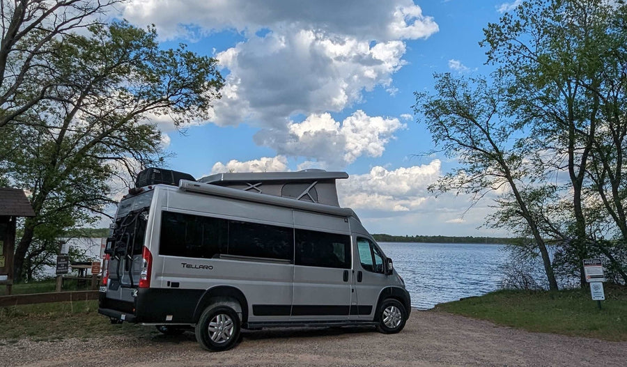 ready to launch into the scenic lake with boat docks.|A gray camper van (Tellaro)