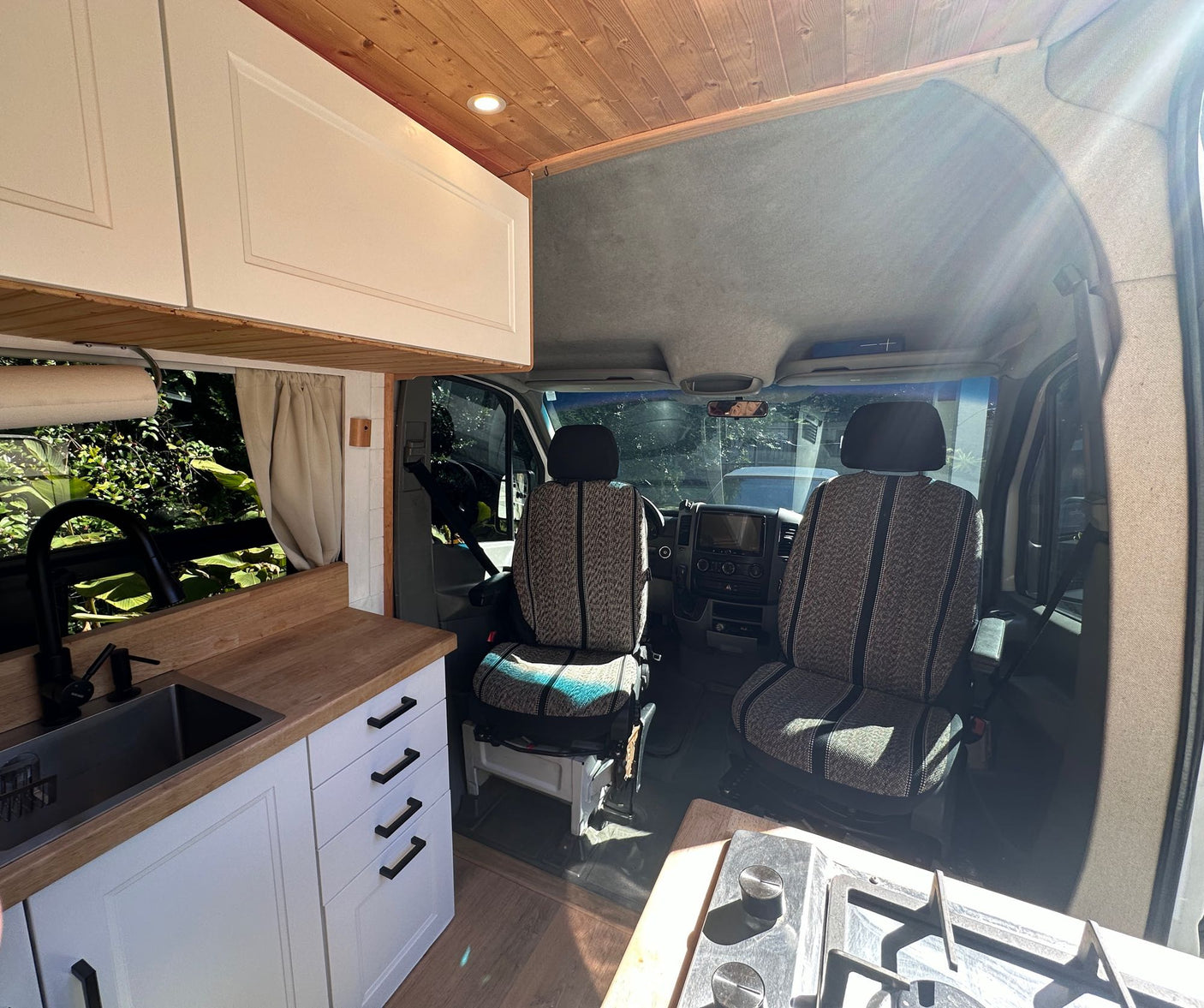 and bright lighting. Perfect for mobile adventures.|Cozy RV rental bedroom with a comfy bed