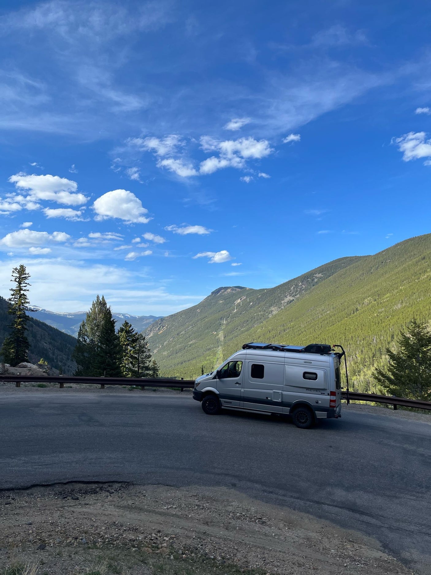 and AC unit. Perfect for compact travel.|Comfortable RV rental bed with plaid blanket and fresh towels