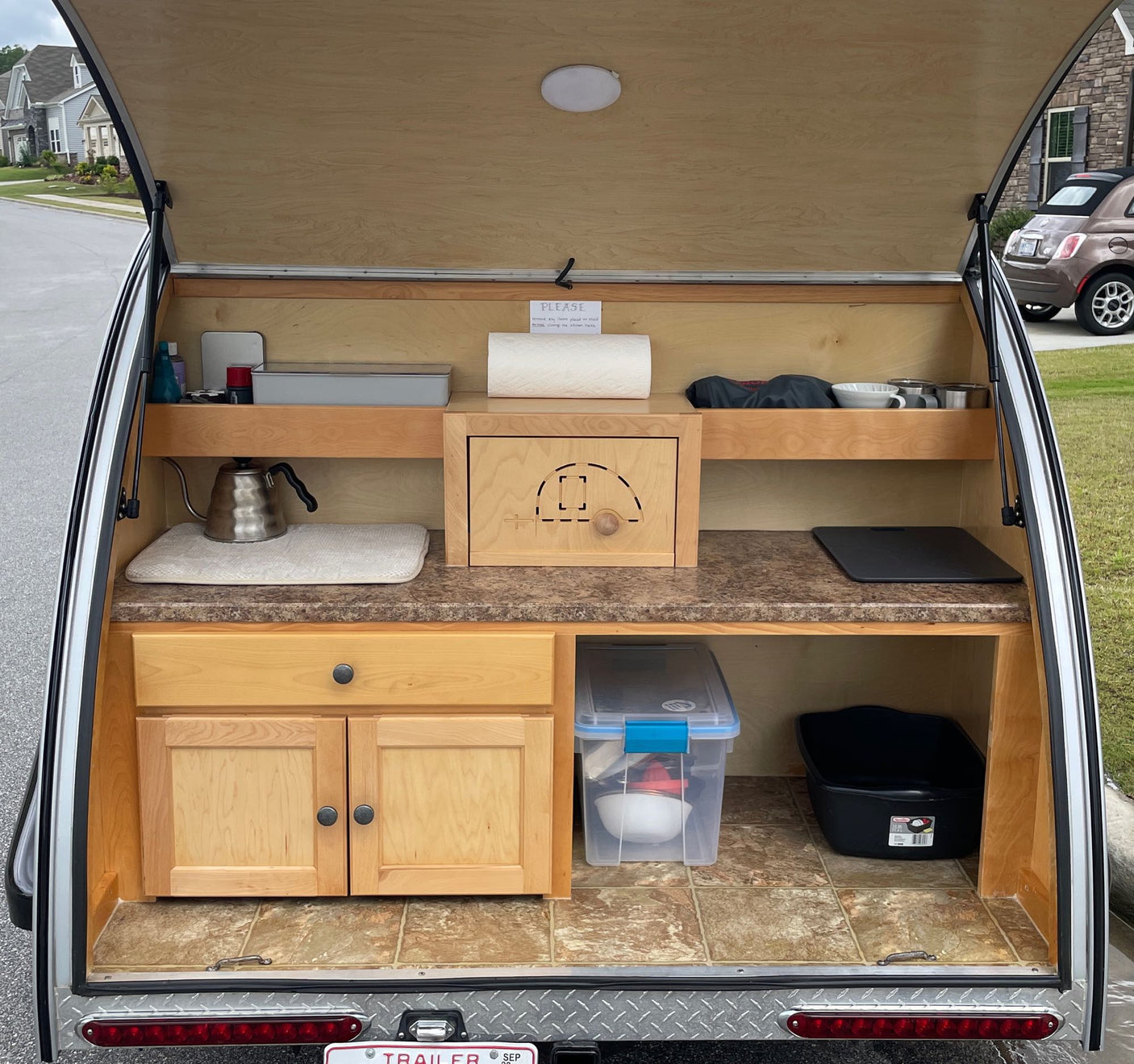 and a snug bed. Ready for travel.|A cozy RV rental bedroom. Bed with patterned pillows