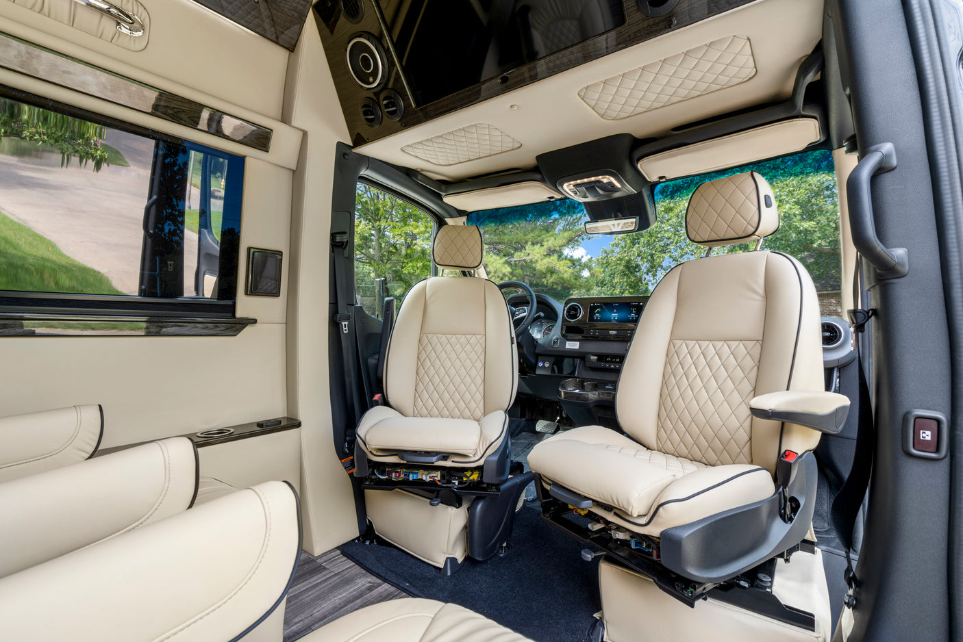Luxurious RV rental interior with cream quilted leather seats, modern dashboard, and spacious design for ultimate travel comfort.