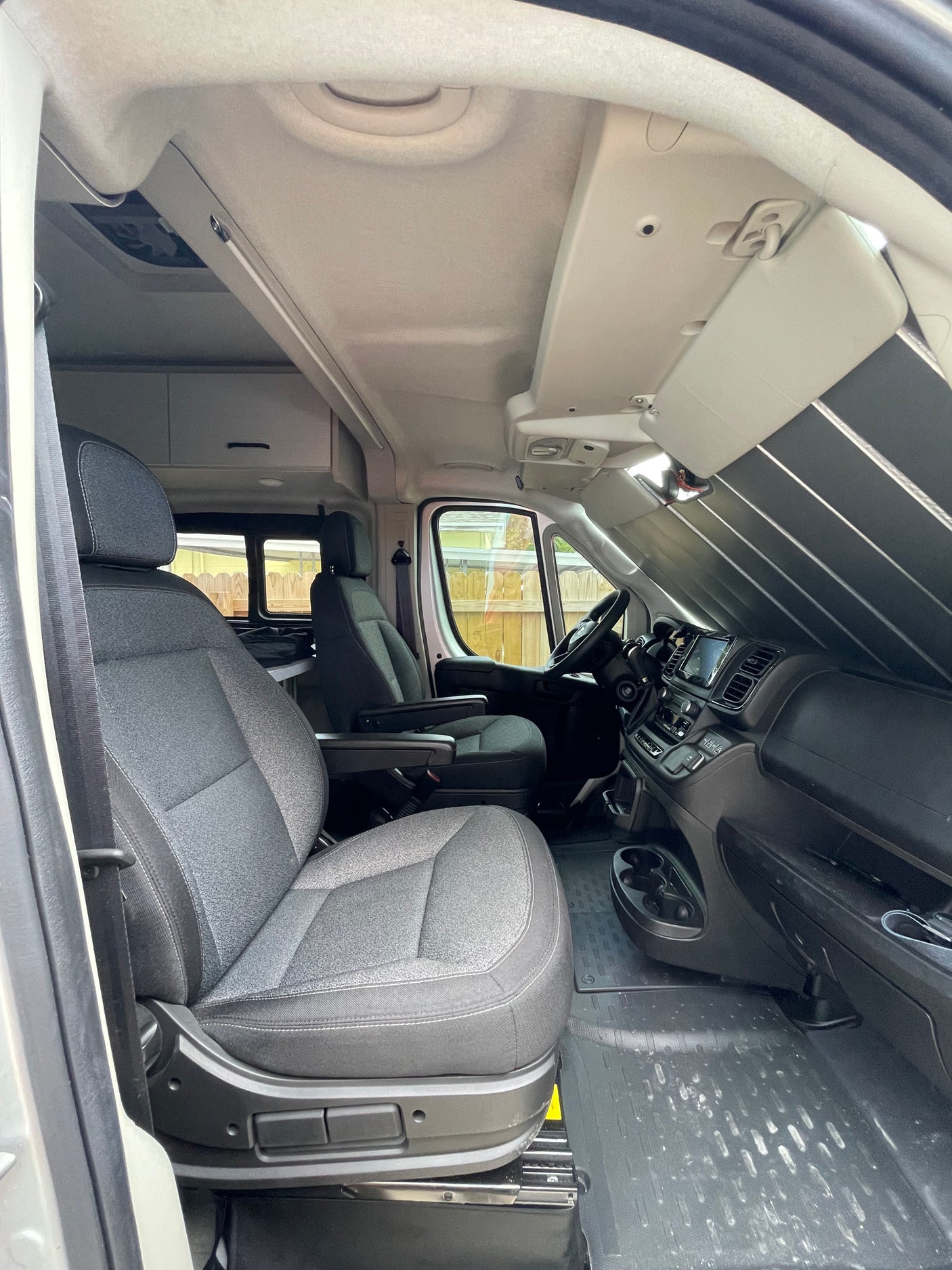 and a cozy bed area.|Inside an RV rental: a comfy bed with tribal patterns