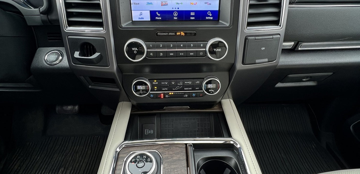 Car interior dashboard, showing infotainment, climate, USBs, and wireless charging. Great for an RV rental experience.
