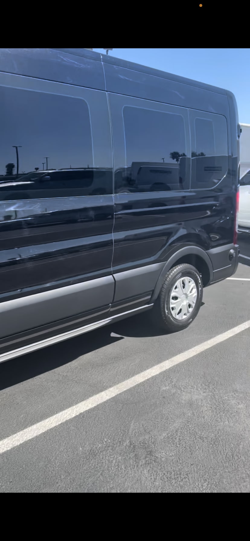 offering comfortable travel.|Experience comfortable group travel! Spacious black leather seating and cup holders inside this luxury RV rental.|Inside a premium RV rental: comfortable black leather captain's chairs with cup holders