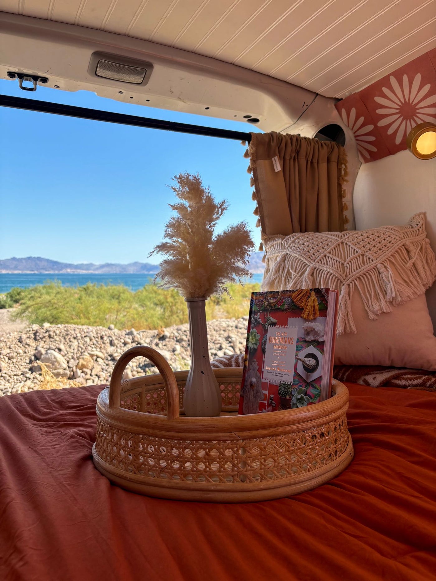 and wooden storage. Perfect for outdoor adventures.|Cozy RV rental bedroom with orange bedding — photo 7