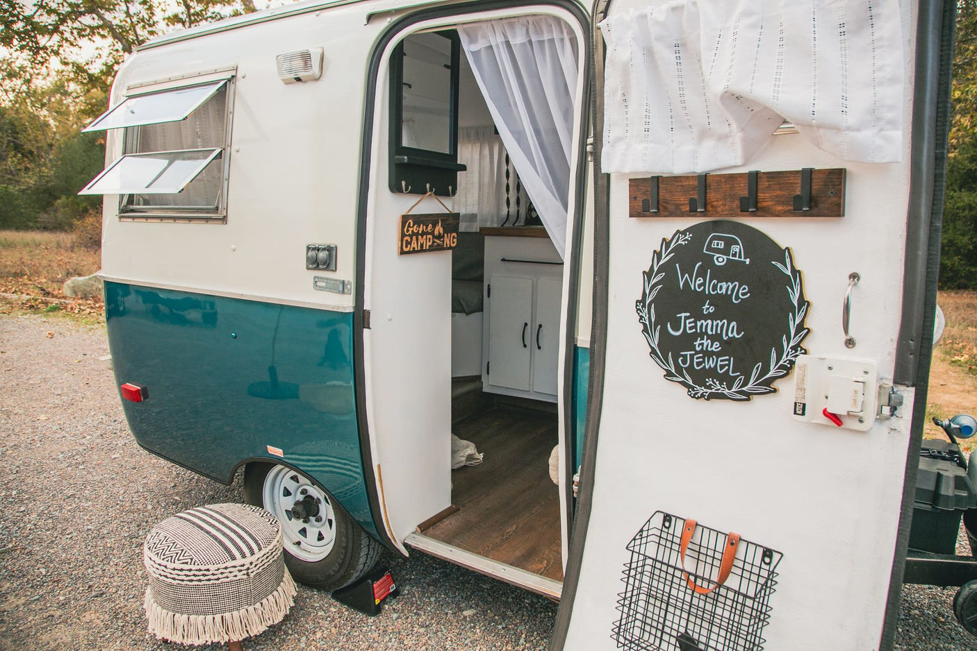 Explore 'Jemma the Jewel', a charming vintage RV rental. Enjoy its cozy interior and unique outdoor setup.