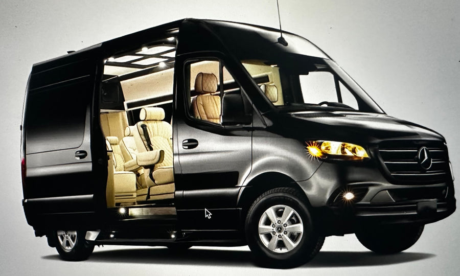 Black Mercedes-Benz Sprinter van with side door open revealing a luxurious tan interior