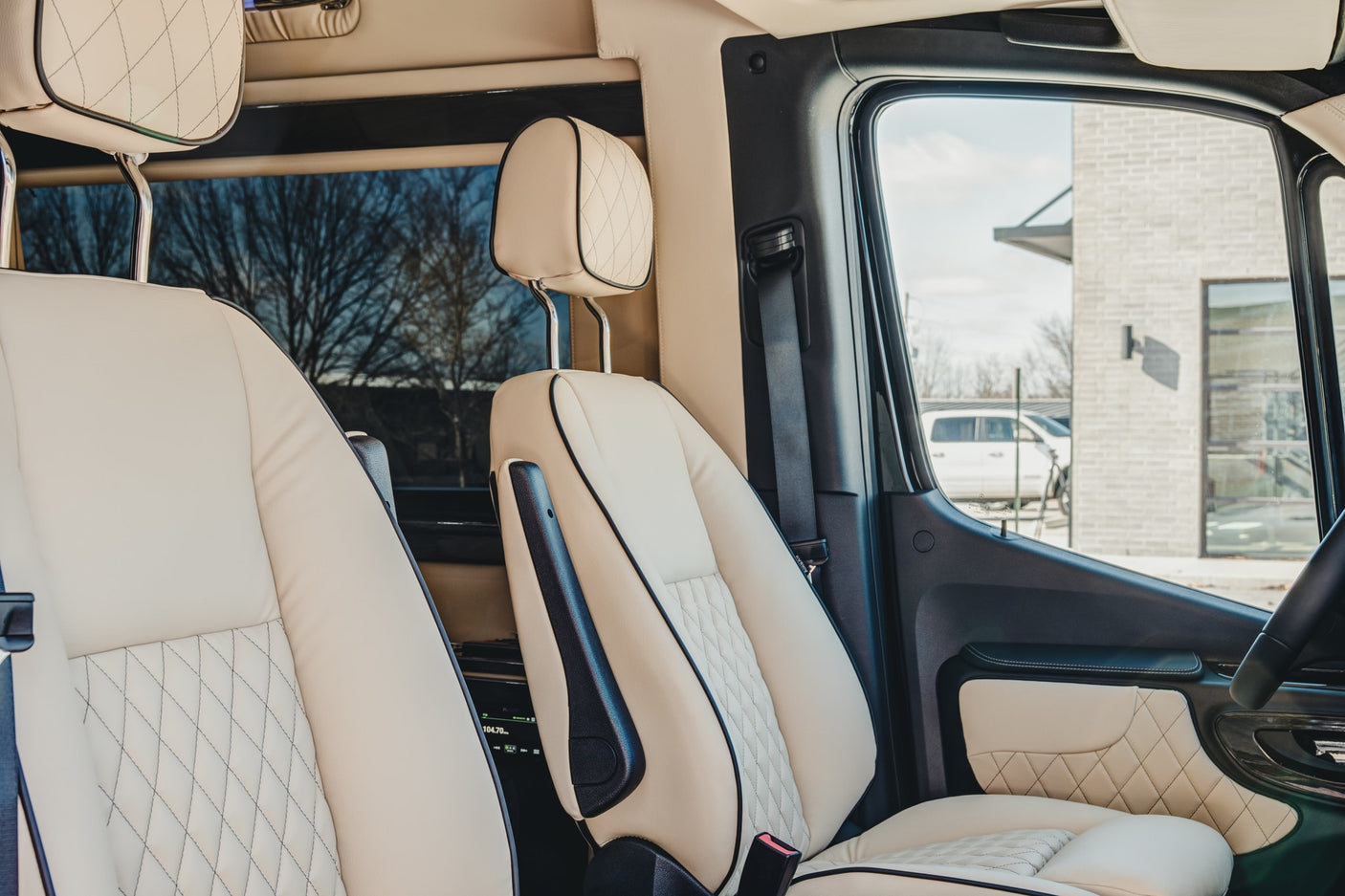 and sleek design.|Premium RV rental interior: elegant cream upholstered seating