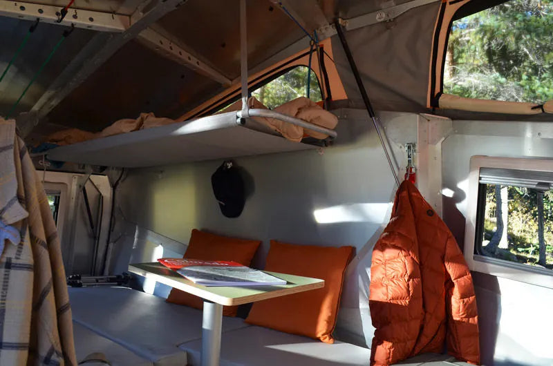 and windows showing a lake view.|Explore comfort in this RV rental's cozy interior — photo 5