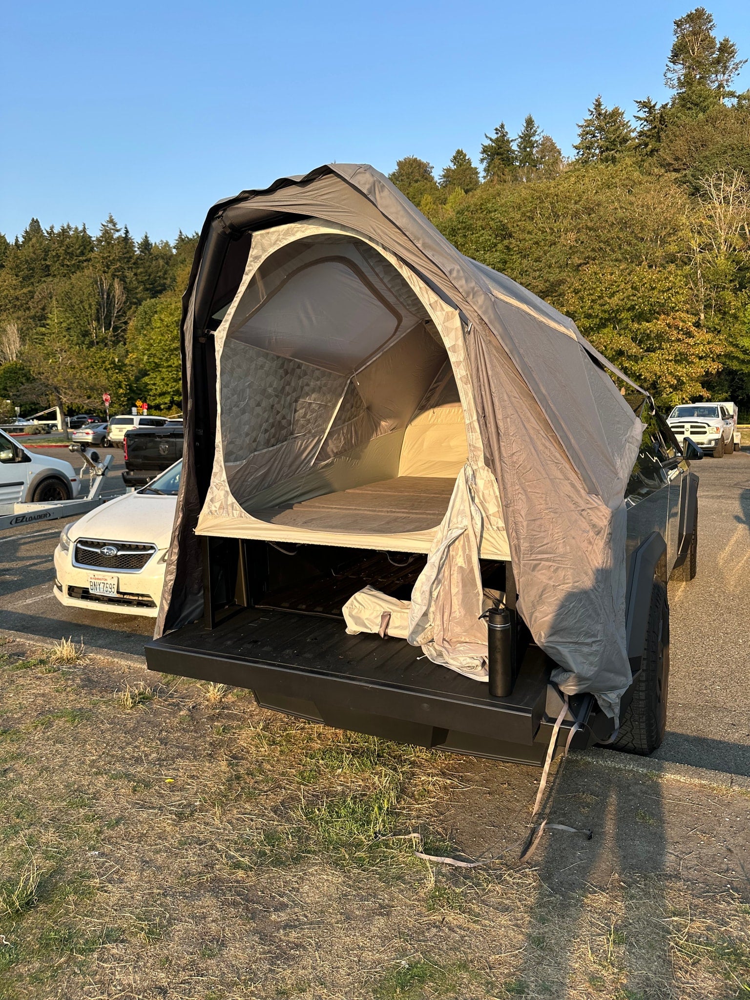 This truck bed tent transforms a pickup into a compact camper for outdoor adventures, a flexible alternative to an RV rental.