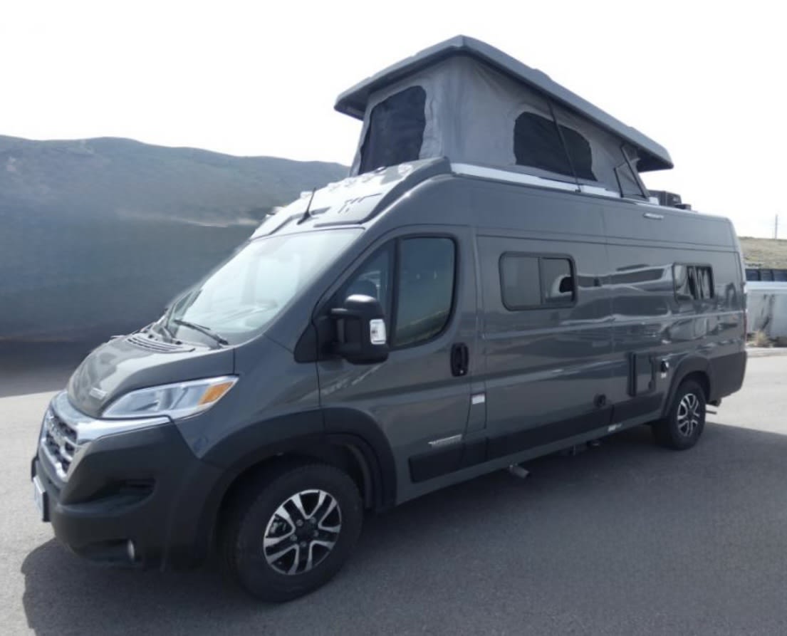 ready for adventure.|RV rental campervan interior: view toward rear doors