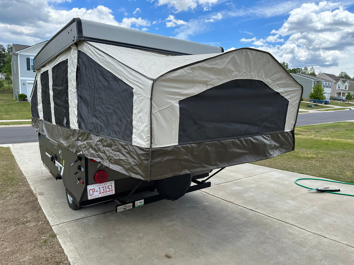 Pop-up RV rental camper with canvas tent deployed, parked on a driveway. — photo 3