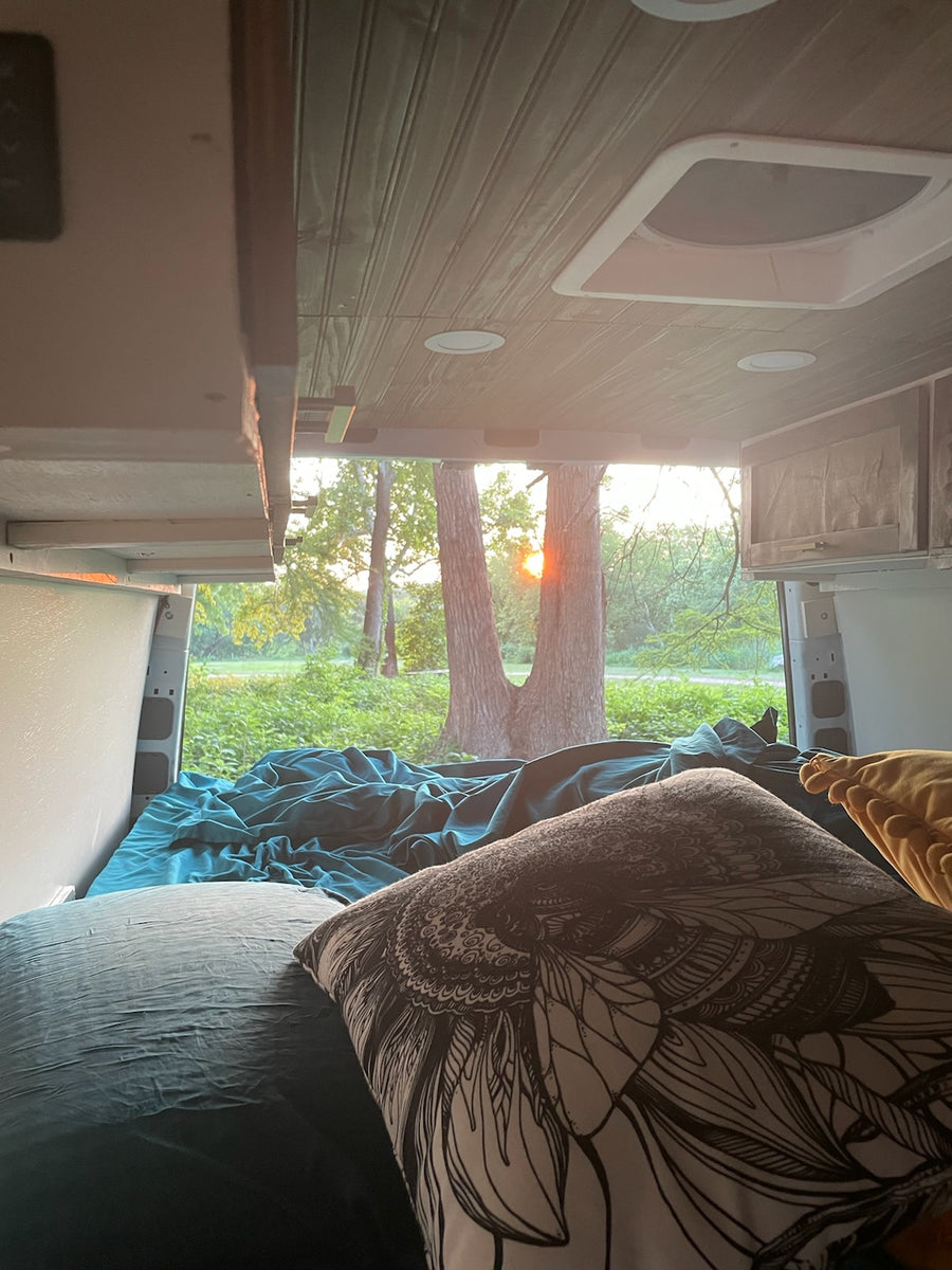 Cozy RV rental bedroom view with teal bedding