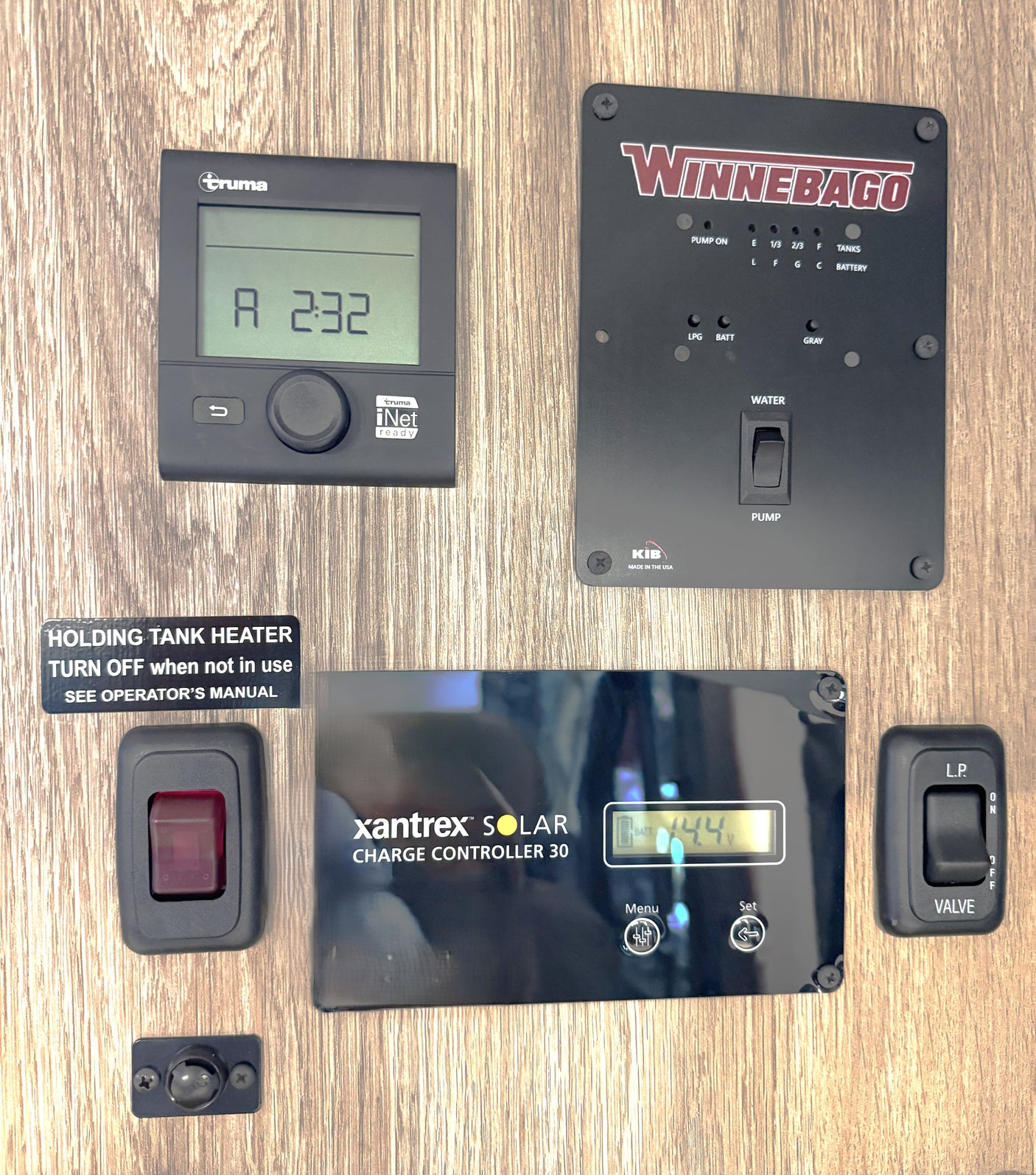 RV rental onboard controls: Truma heater, solar charge controller, water pump, tank levels, and holding tank heater.
