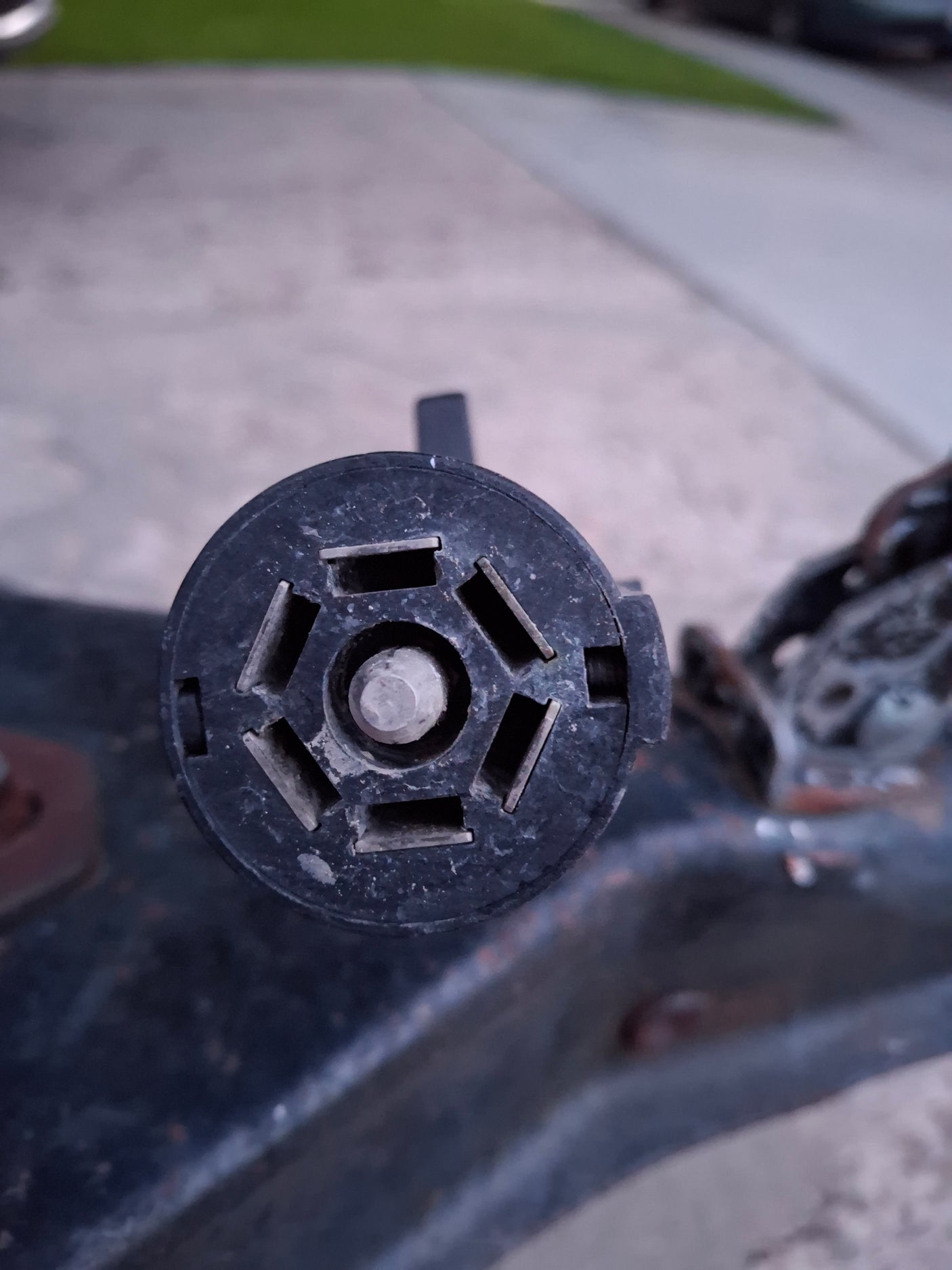 A black 7-pin electrical connector for RV rental trailers, shown close-up, providing power and lights for safe towing.