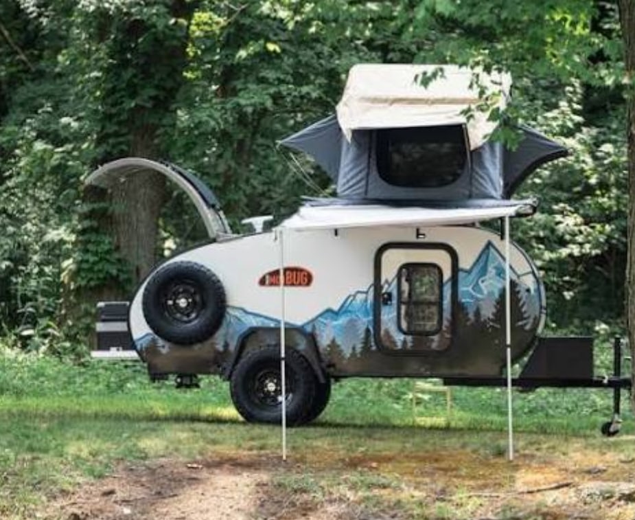 and electric fireplace. Enjoy relaxing amenities in this compact space.|Compact RV rental kitchen with sink