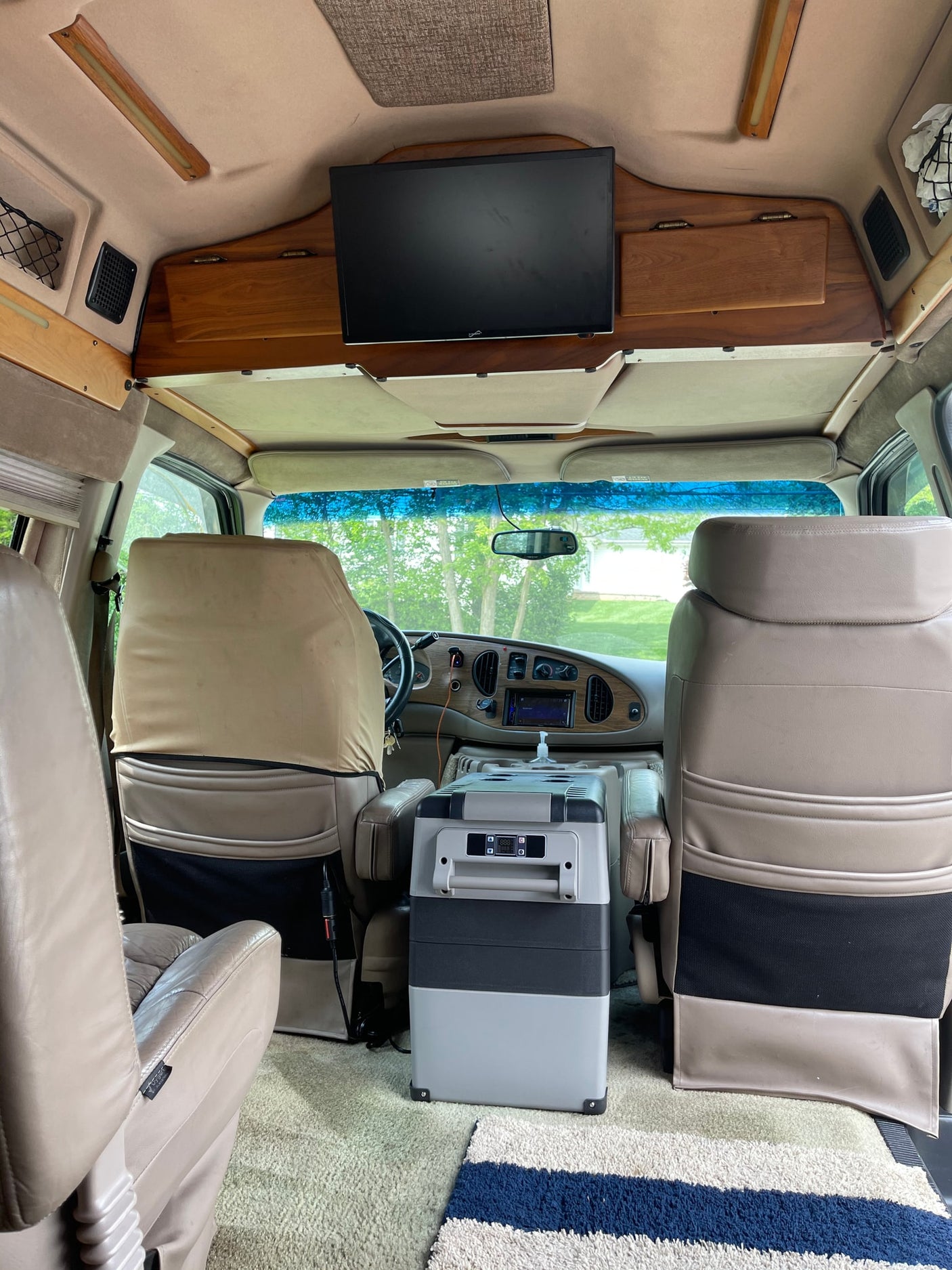 white portable toilet sits on the beige carpet of an RV rental