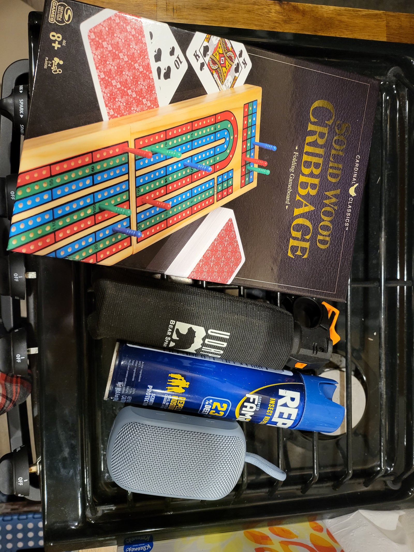 RV rental prep: Cardinal Cribbage, UDAP Bear Spray, Repel insect repellent, and a portable speaker for the trip.