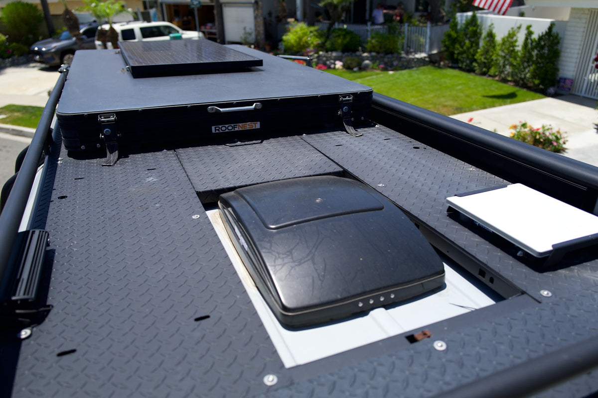 RV rental's roof: black Roofnest rooftop tent with solar panel and vent. Equipped for outdoor adventure. — photo 10