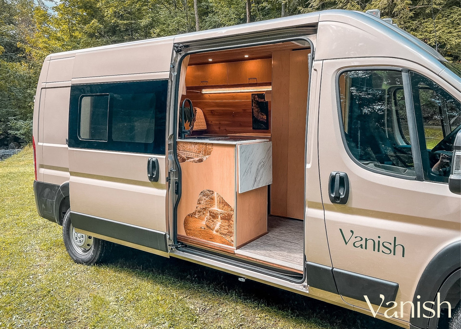 & kitchen in a spacious camper van. Perfect for adventures!|Serene RV rental escape: person in cozy campervan enjoys coffee with a blanket