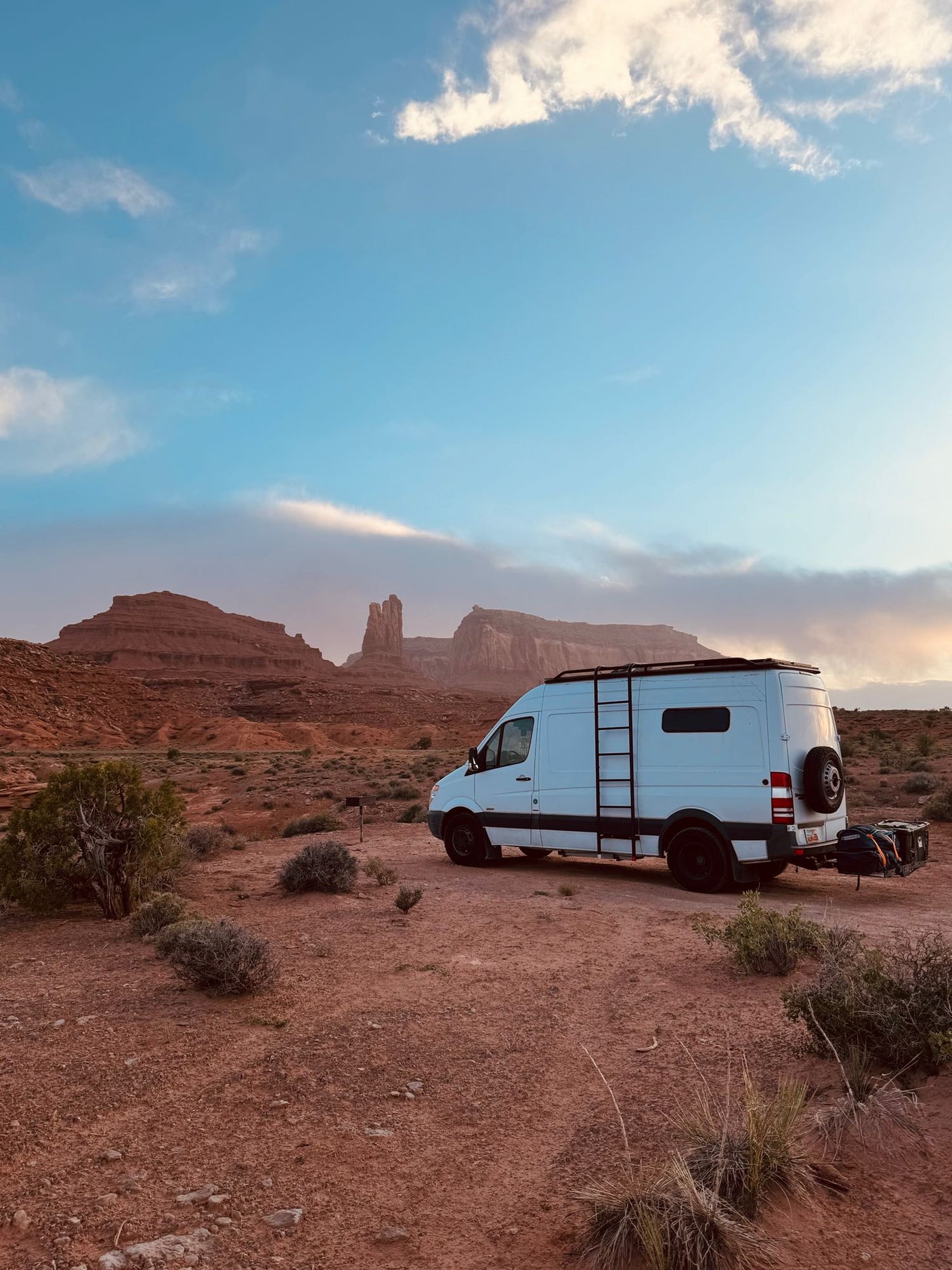 RV rental camper van parked in a stunning red rock desert landscape