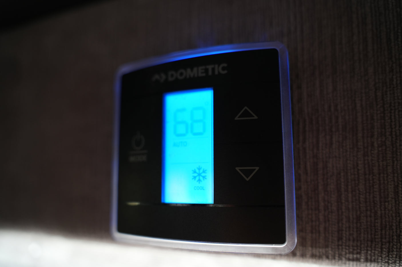 RV rental Dometic climate control set to cool at 68°F in auto mode, with clear up/down temperature controls.