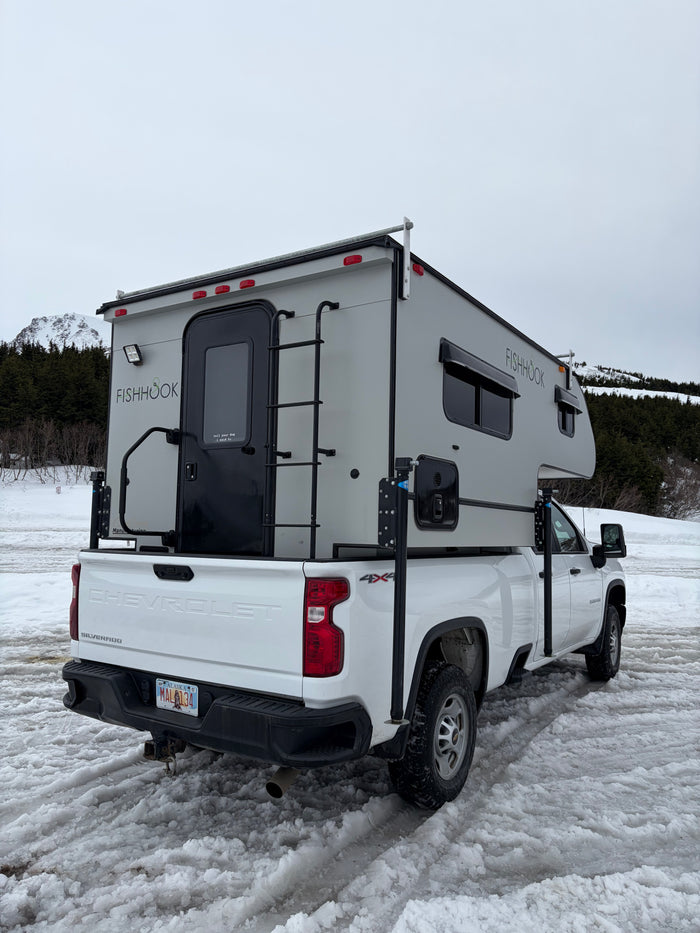 great for an RV rental winter adventure.|This Fishhook truck camper on a white Chevy Silverado is a great RV rental for snowy Alaskan adventures.|This white pickup truck