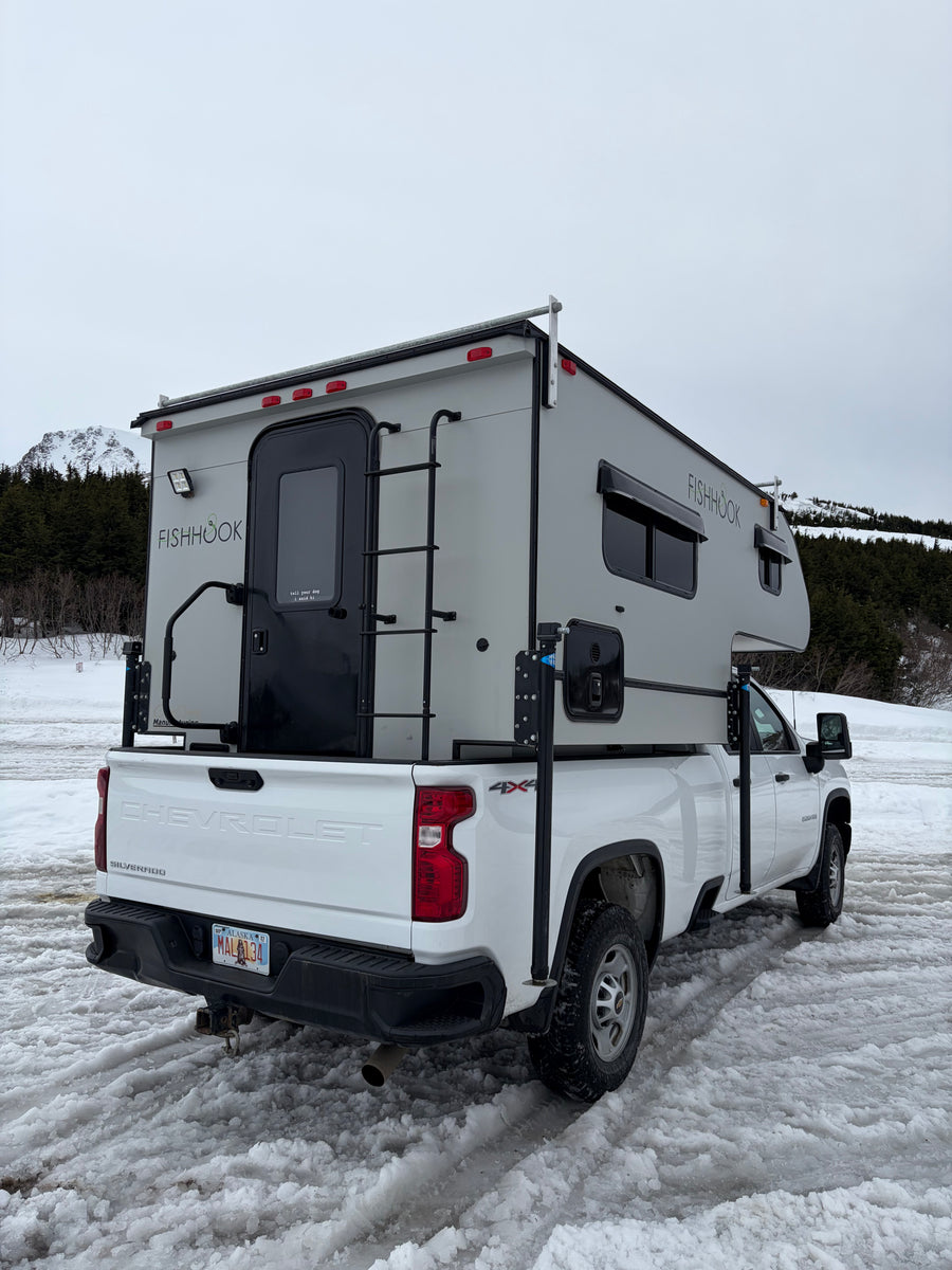 great for an RV rental winter adventure.|This Fishhook truck camper on a white Chevy Silverado is a great RV rental for snowy Alaskan adventures.|This white pickup truck