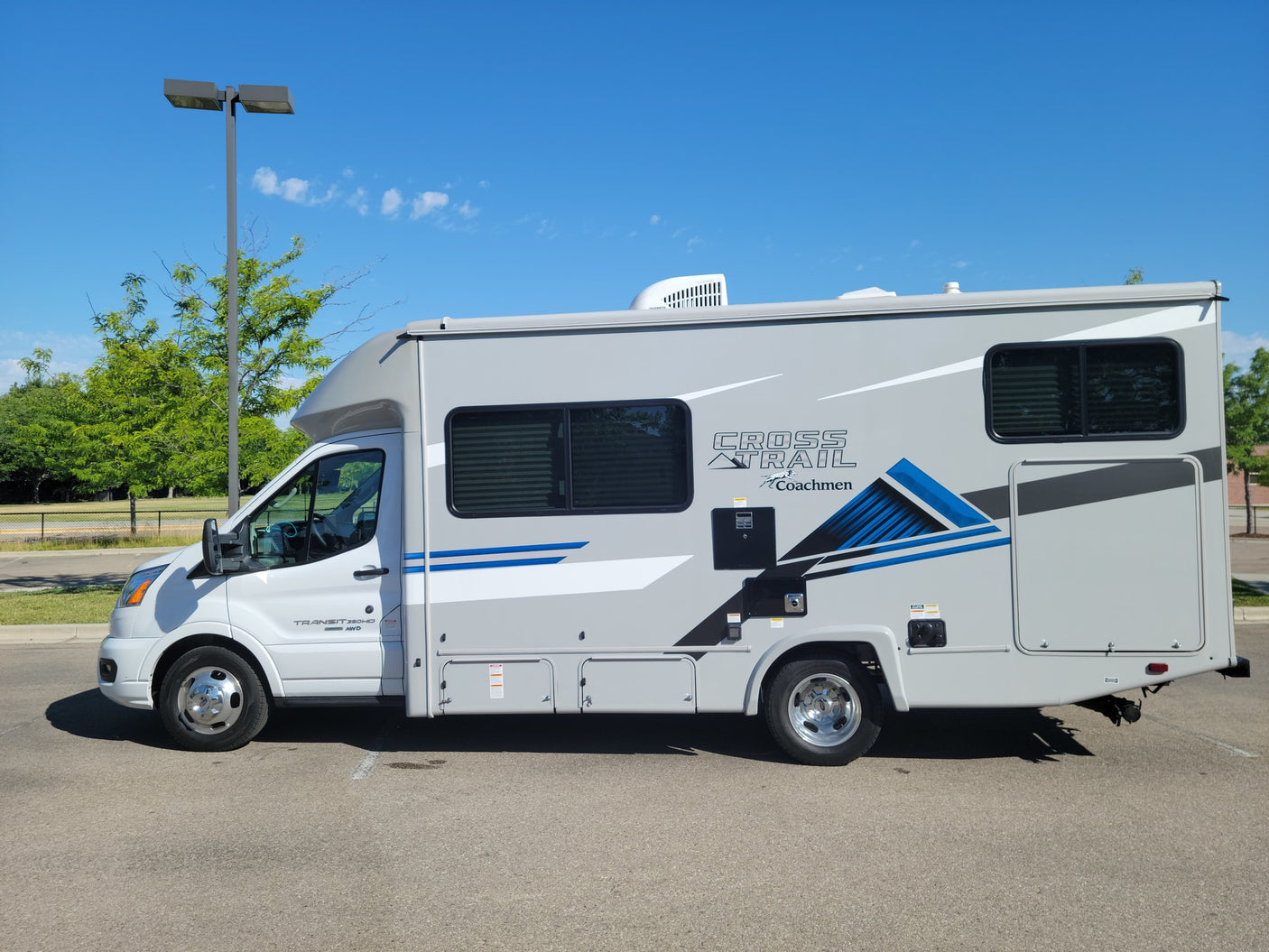 Sleek grey Coachmen Cross Trail Class C RV rental parked outdoors, ready for your next travel adventure.